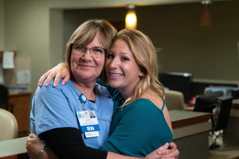 Spine Surgery Patient hugs mom after recovering from car accident.