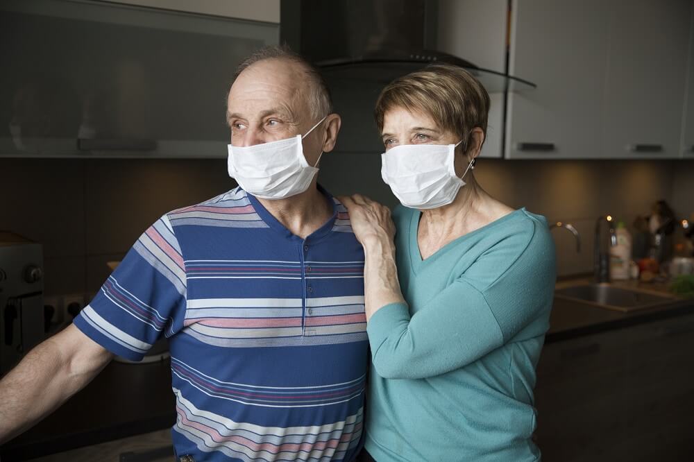 Senior couple wearing masks to protect against COVID-19