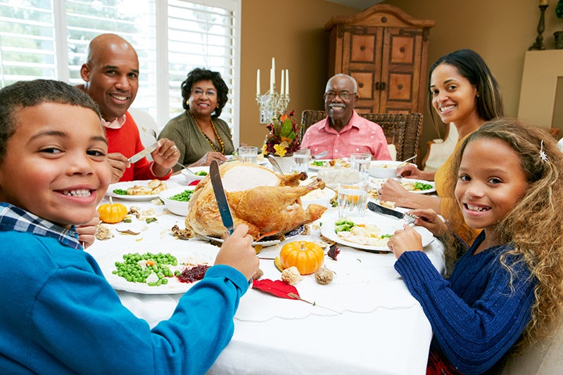 african american family sat around dinner table