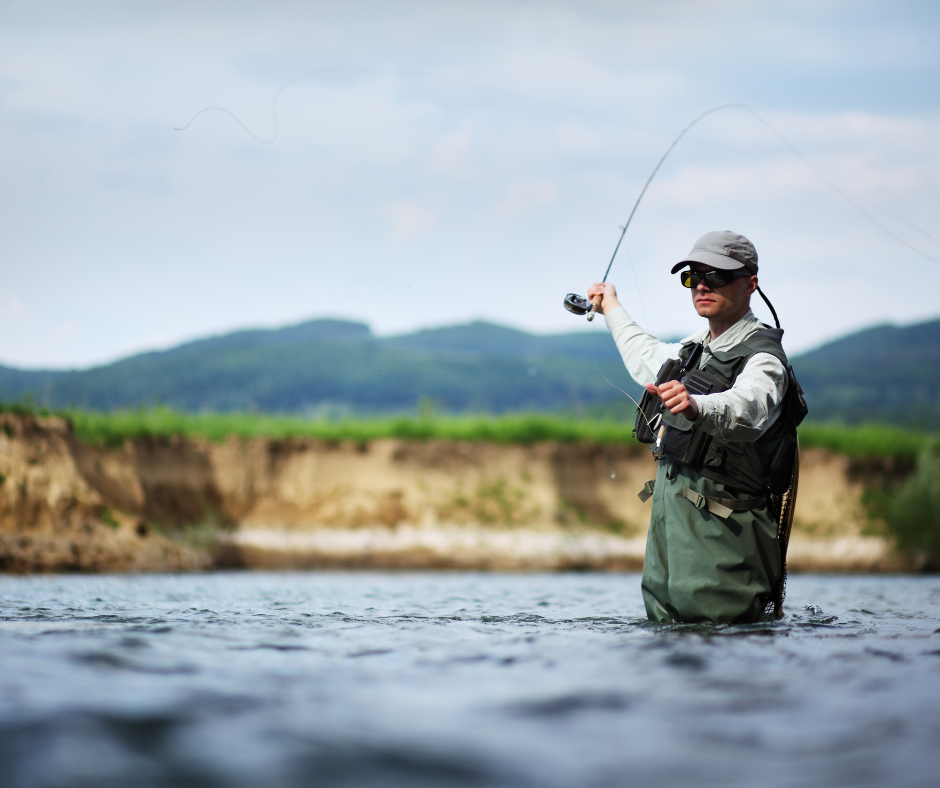 "man fly fishing in river"