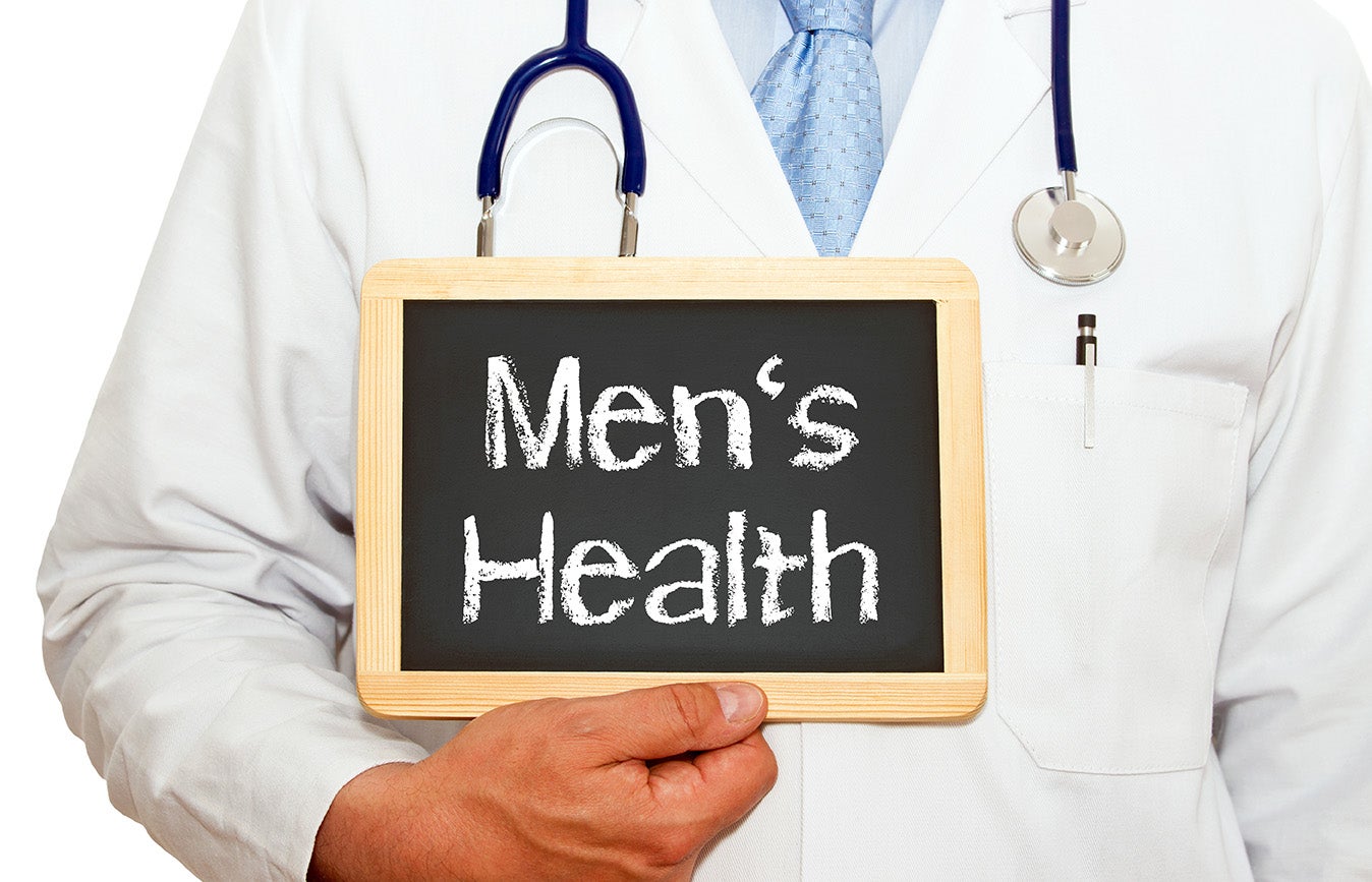 "doctor holding sign reading Men's Health"