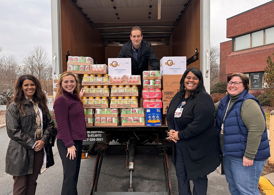 "Staff with donated food loading into Food Farmacy Truck"
