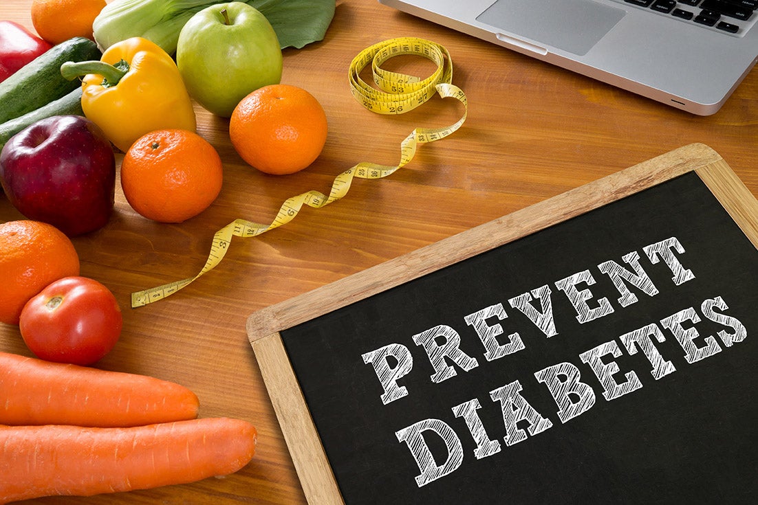 "Healthy food and a board that reads Diabetes Prevention"