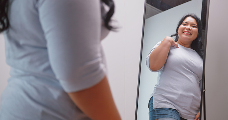 woman looking at herself in mirror