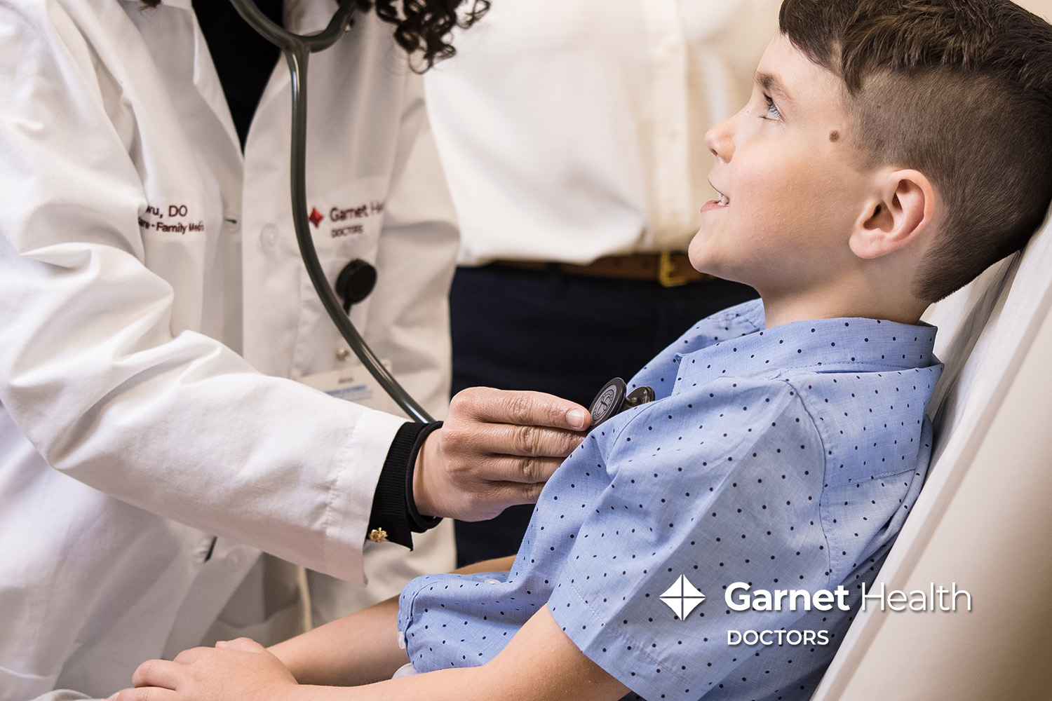Garnet Health Doctors Physician listening to a child's breathing with a stethoscope