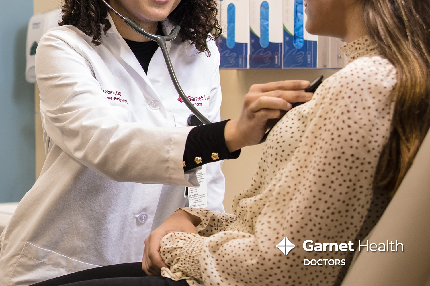 Garnet Health Doctors female physician listening to a woman's breathing with a stethoscope
