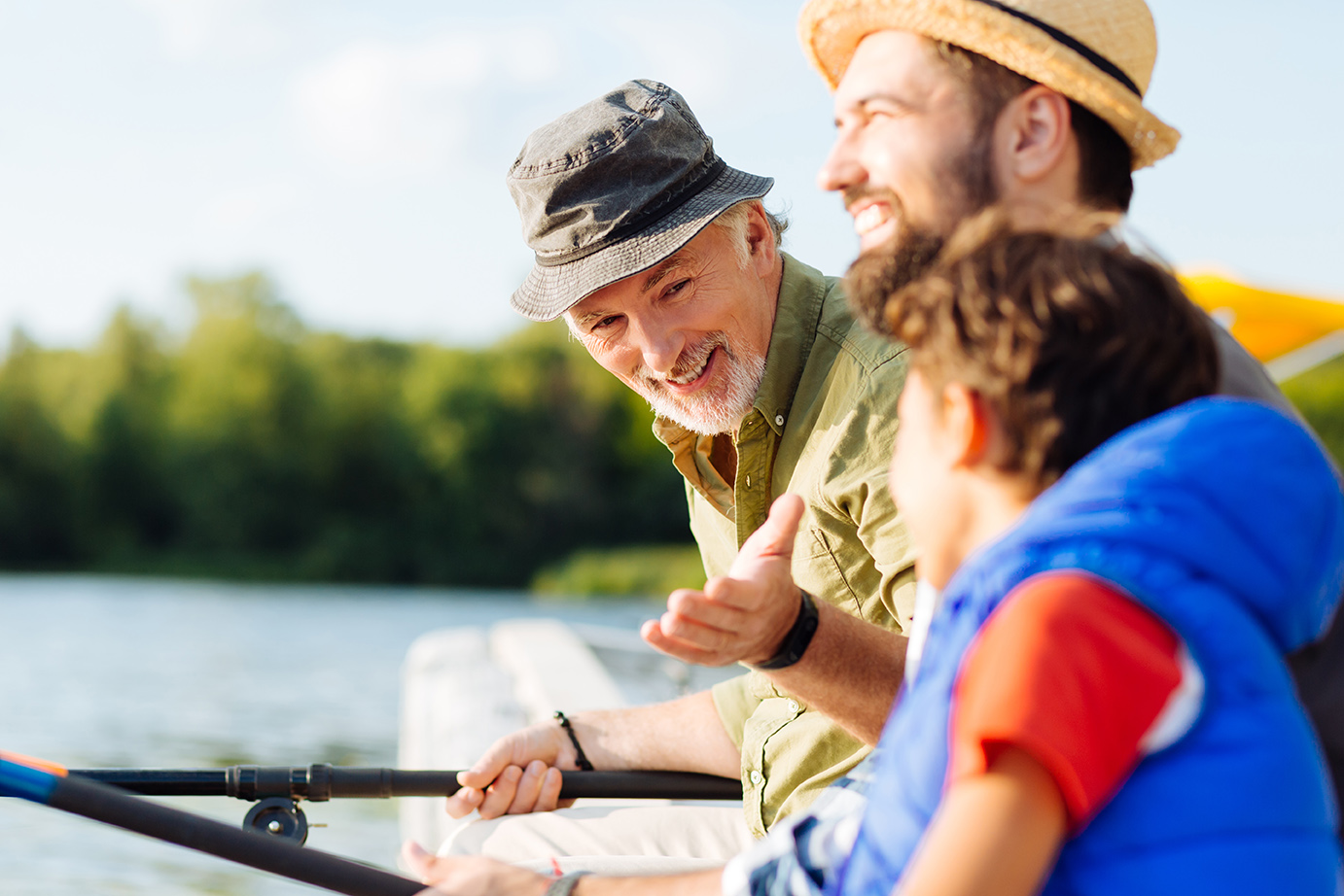 Grandfather fishing with son and grandson.