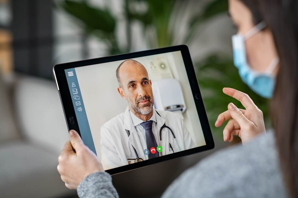 Patient speaks with doctor via telehealth appointment on her ipad