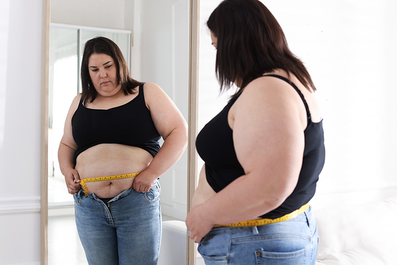 woman measuring herself with a tape measure